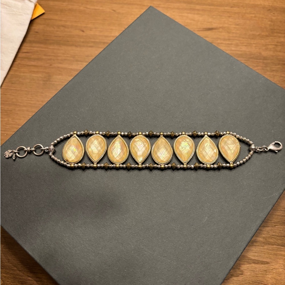 Lucky Brand bracelet, 8” long. Silver and brass color. Drop shaped links.